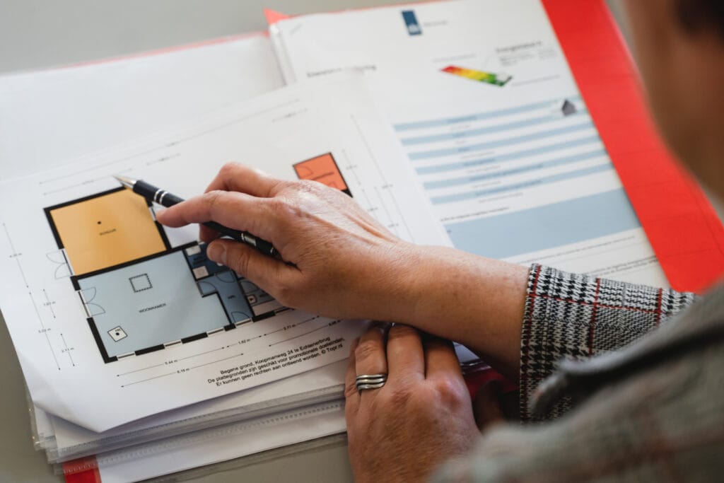 Plattegrond en documenten van een woning op tafel